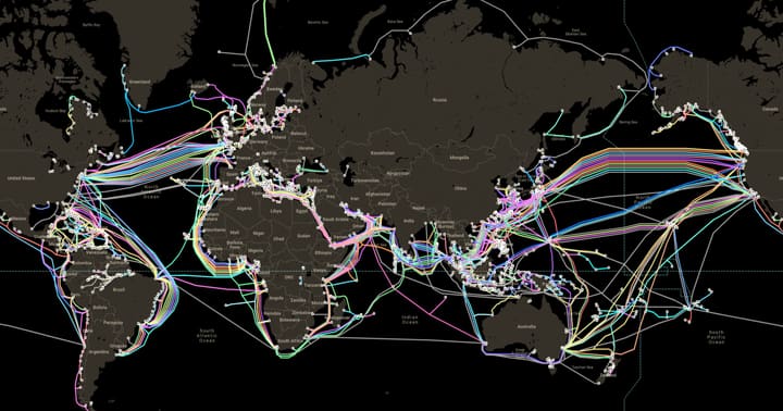 World map of submarine cables as coloured routes on a dark ocean.